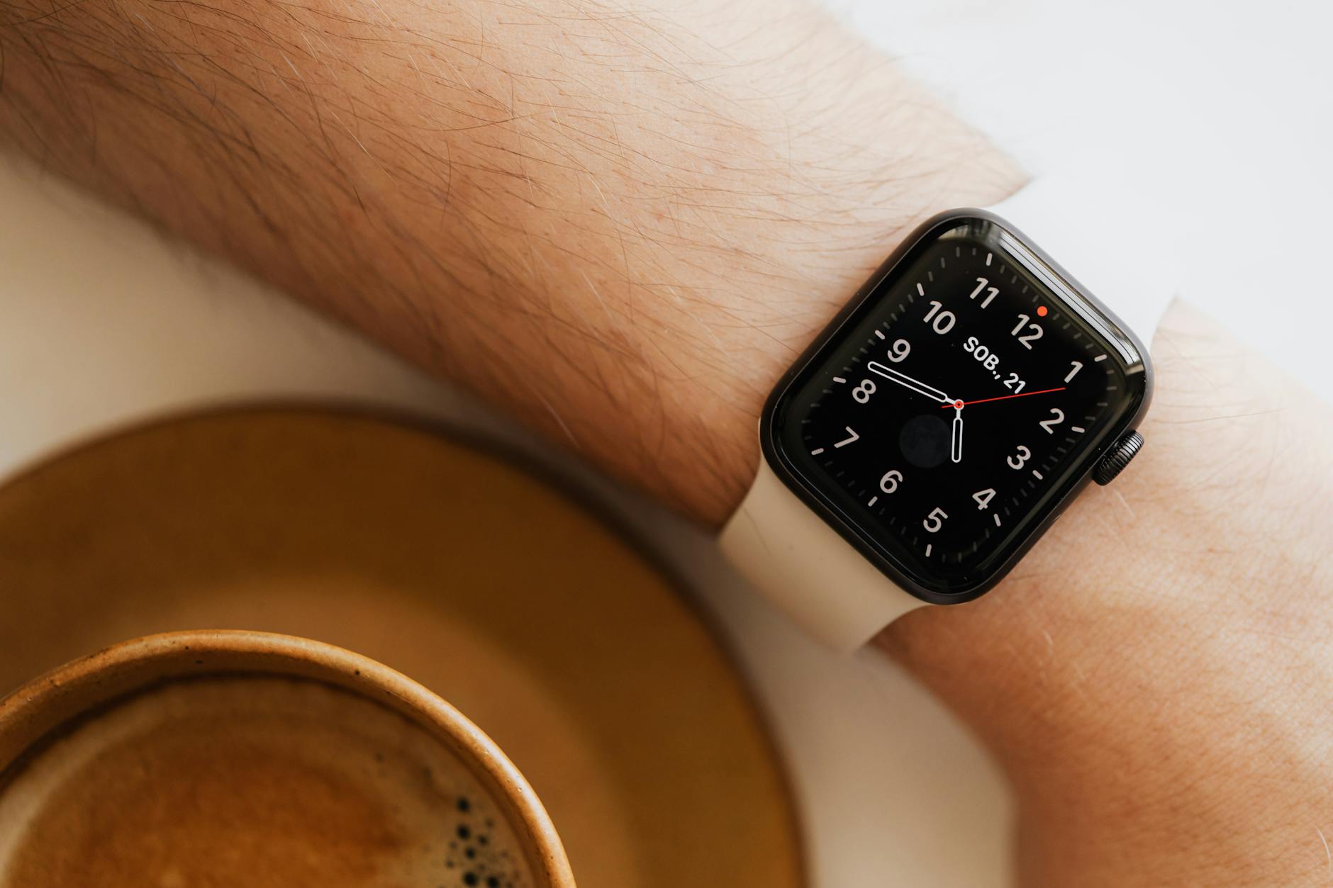 faceless man wearing smart watch and drink coffee