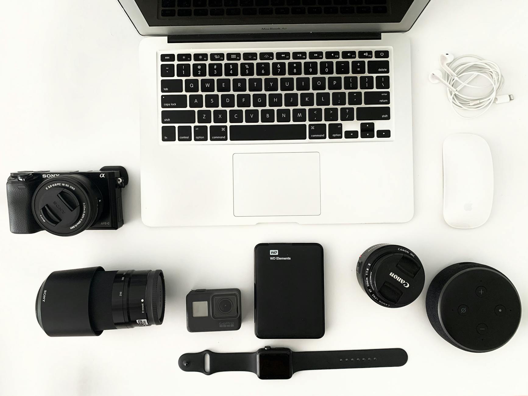 laptop with photo camera accessories on white background